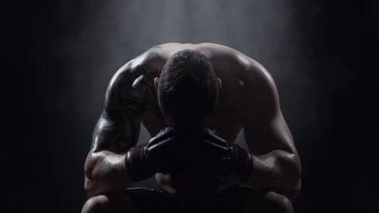 Boxer with head in hands and text overlay reading 'CBD for PTSD'