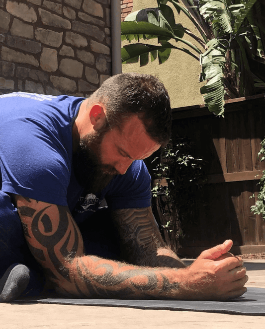 Jason Higgins stretching at home in California to manage back pain with CBD