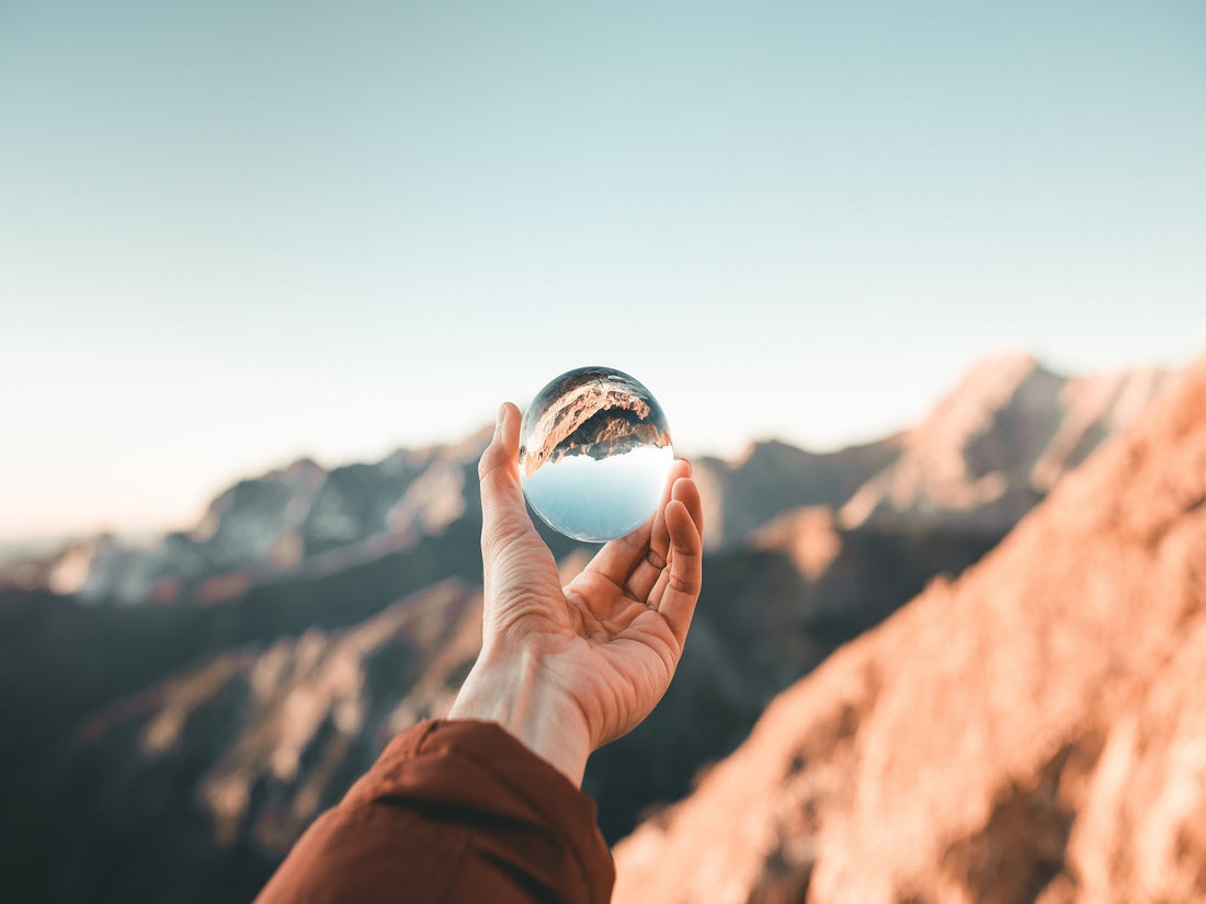 looking at a mountain view through transparent globe