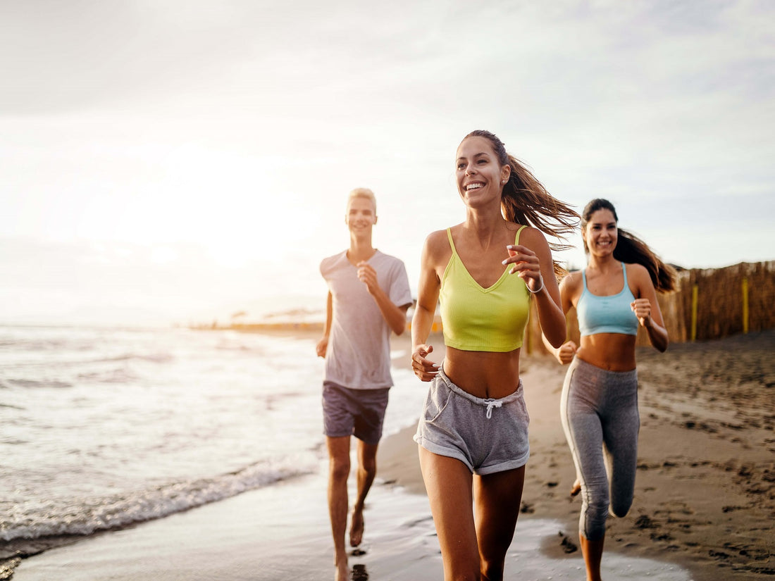 group of friends exercising on the beach