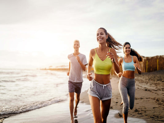 group of friends exercising on the beach